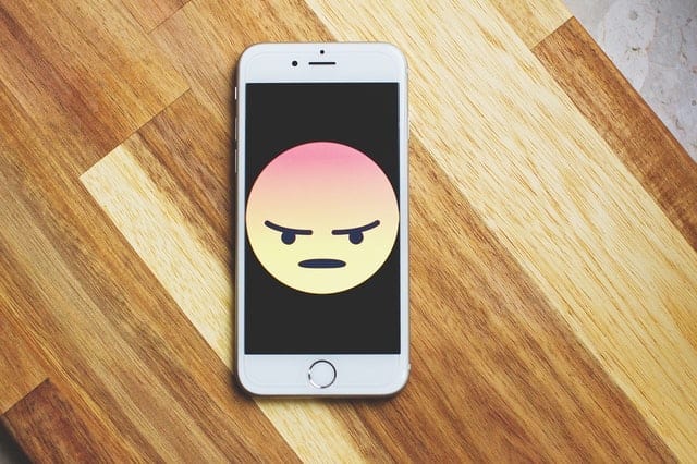 mobile phone with angry emoji
