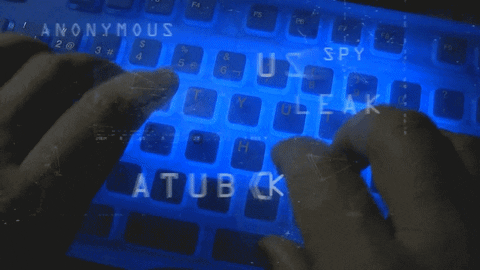 A pair of hands types on a keyboard as words about cyber security and data protection float over top